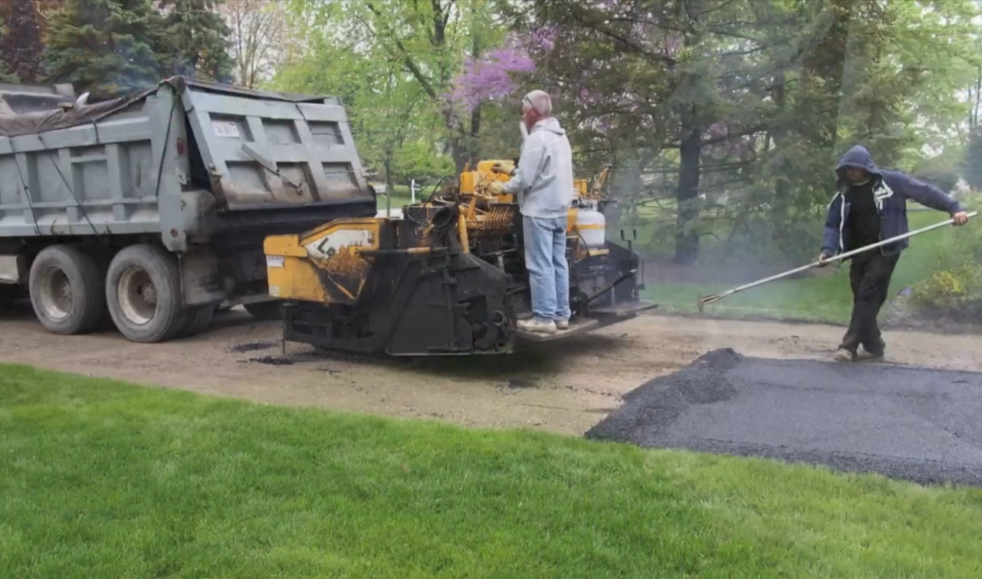 Asphalt crew spreading asphalt