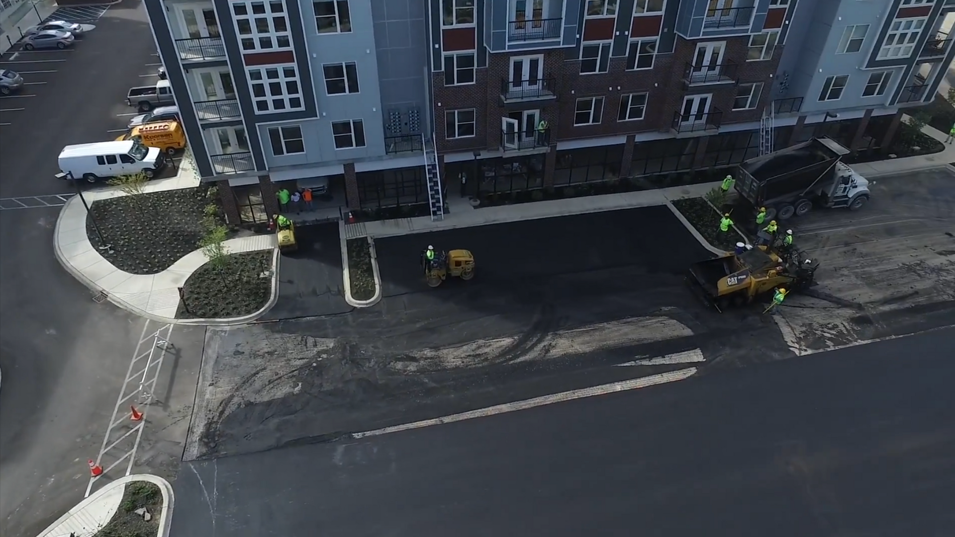 Concrete walkway with rock and driveway