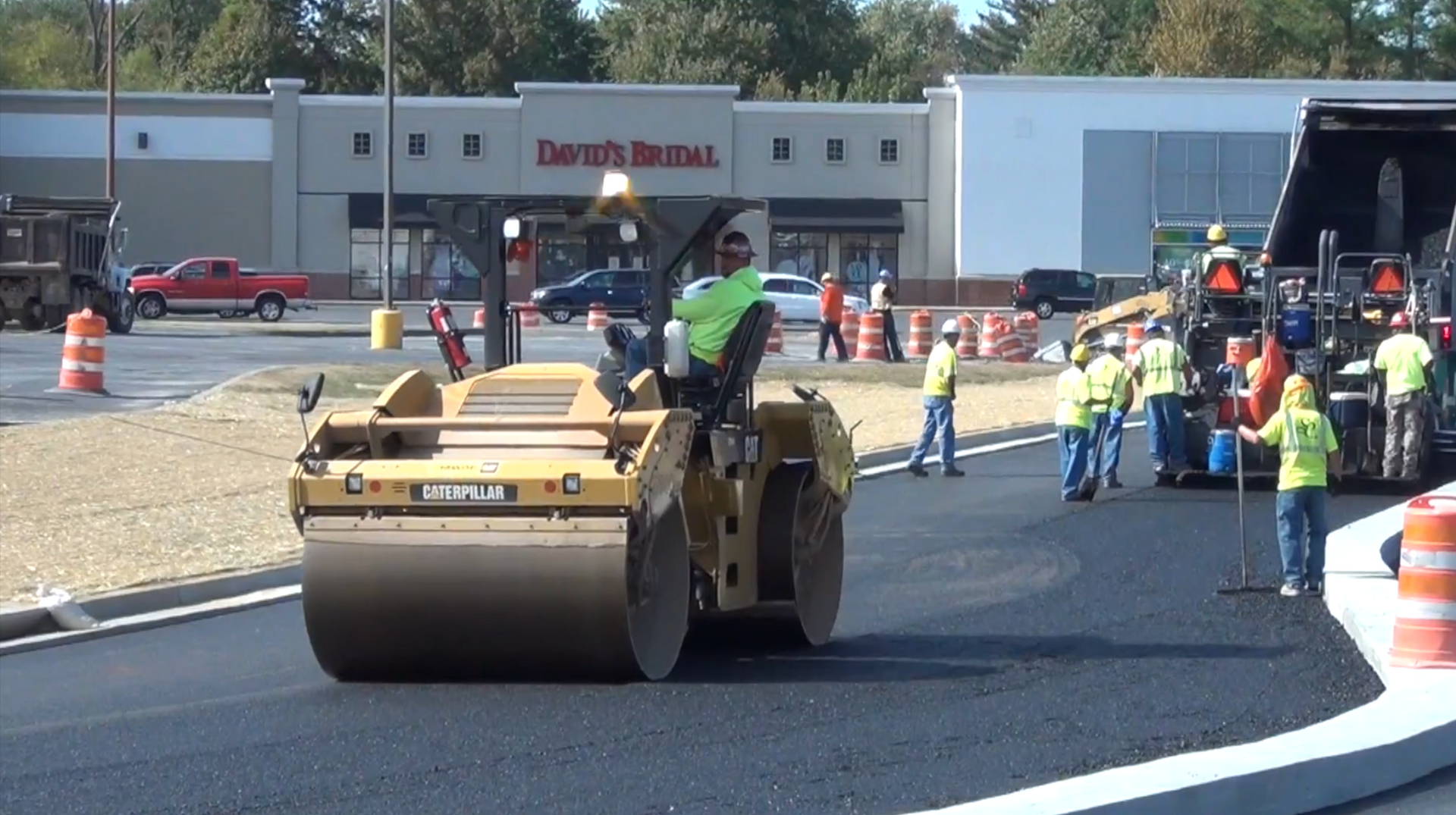 Crew using rollers to install asphalt parking lot
