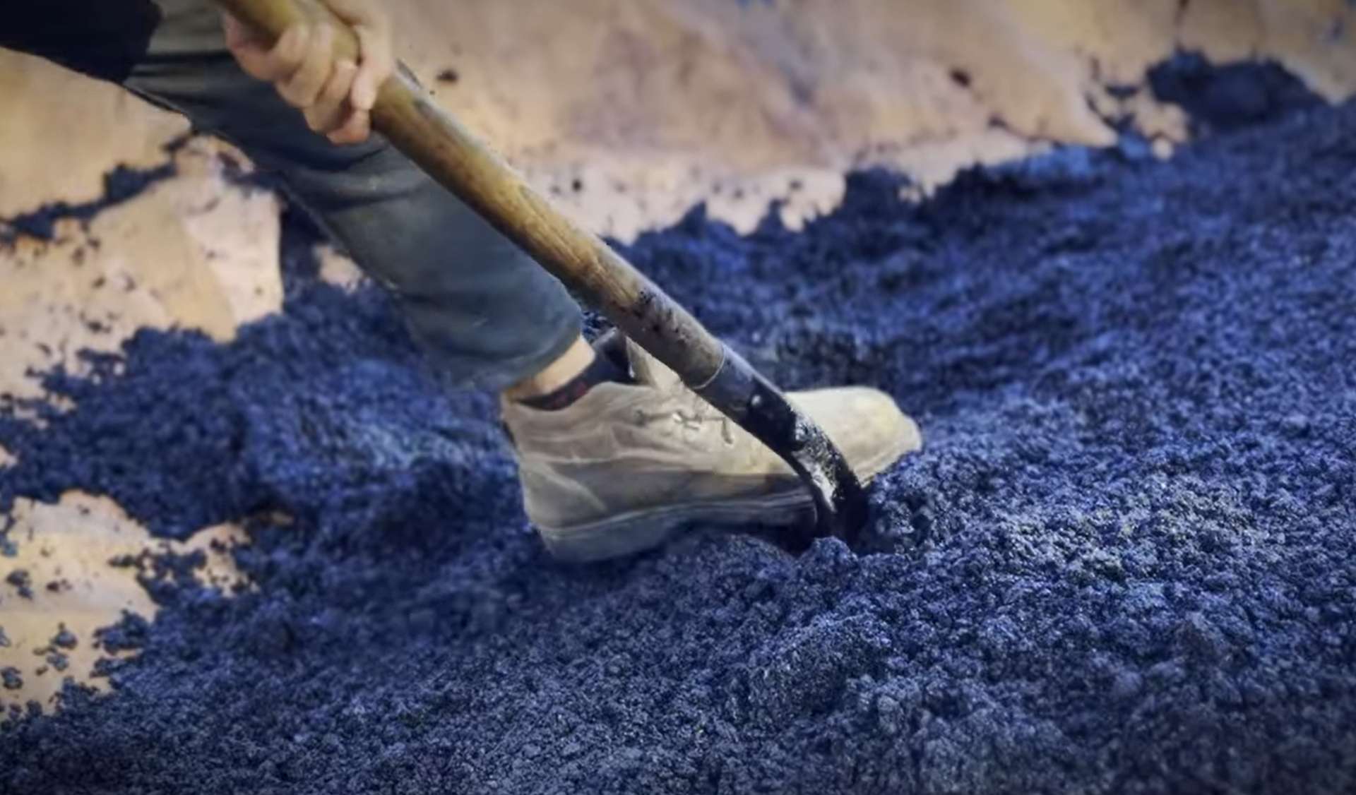 Crew shoveling asphalt