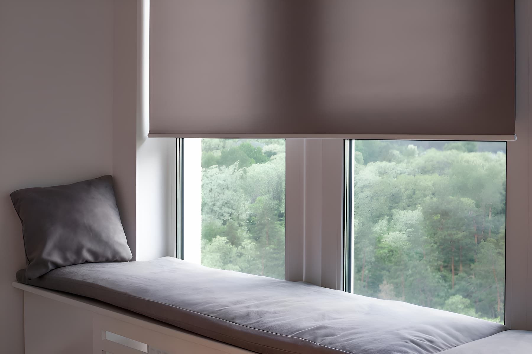 A Window Seat With a Cushion and a Pillow in Front of a Window — Manning Blinds & Awnings in Taree, NSW