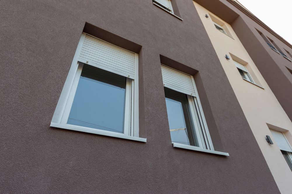 A Building With Two Windows on the Side of It — Manning Blinds & Awnings in Taree, NSW