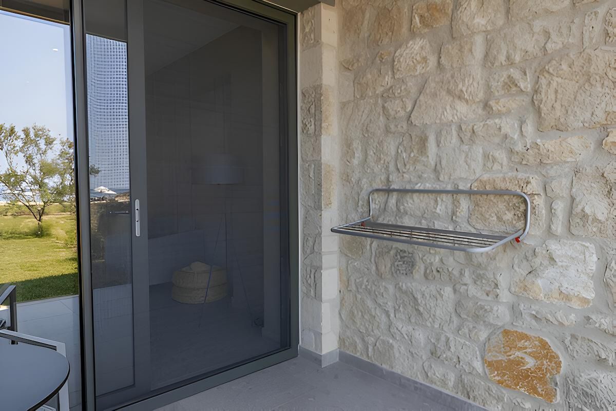 A Window on the Side of a Building With Blinds on It — Manning Blinds & Awnings in Taree, NSW