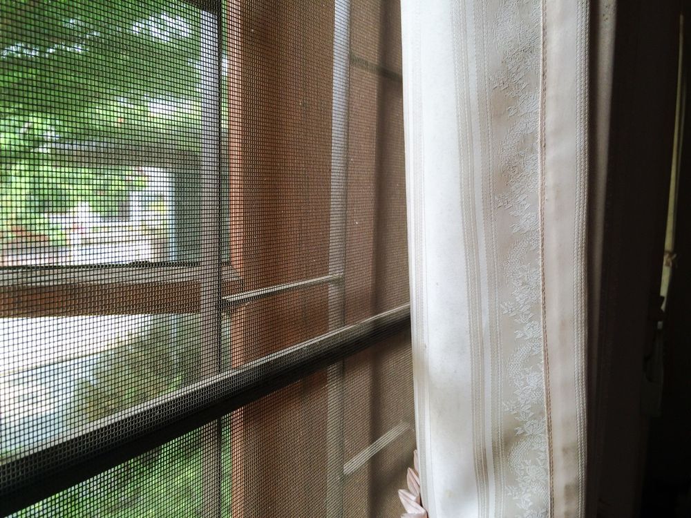 A Close Up of a Window With a Screen on It — Manning Blinds & Awnings in Taree, NSW