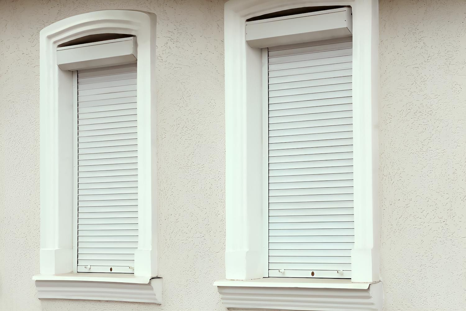Two Windows With Shutters on Them on the Side of a Building — Manning Blinds & Awnings in Taree, NSW