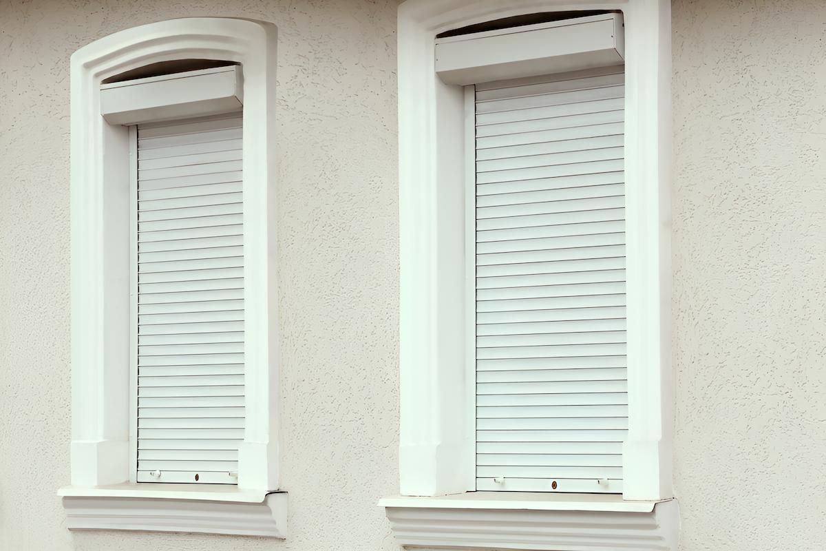 Two Windows With Shutters on Them on the Side of a Building — Manning Blinds & Awnings in Taree, NSW