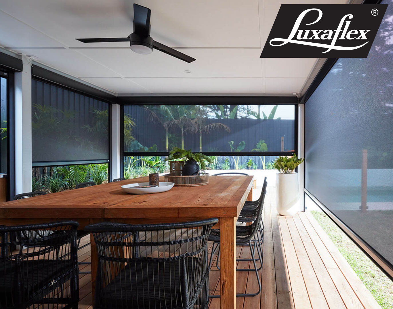 A White House With a Black Awning on the Side of It — Manning Blinds & Awnings in Taree, NSW