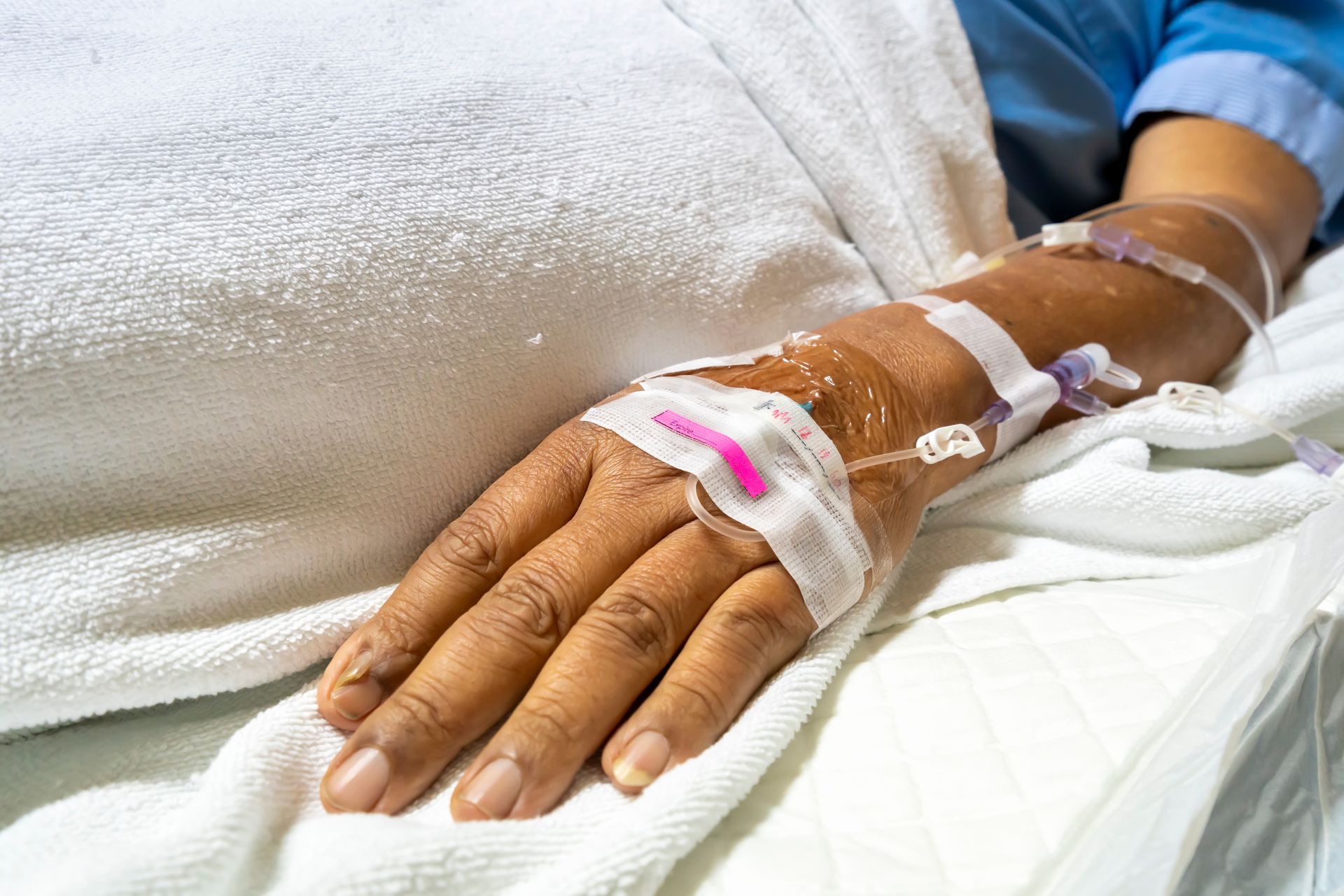 Hand of the patient is on drip receiving a saline solution.