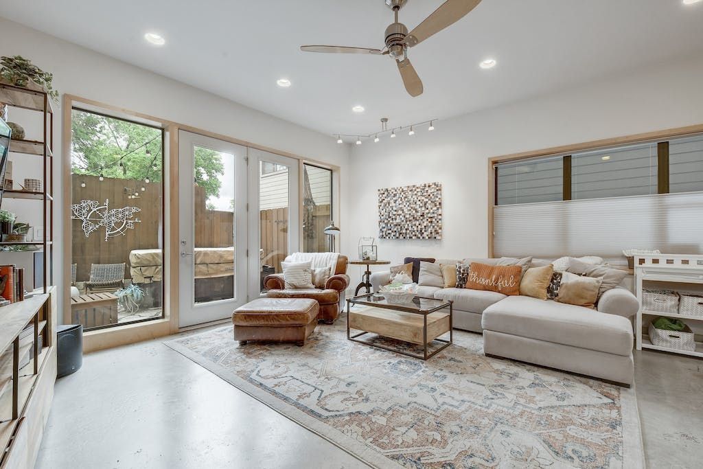 A living room filled with furniture and a ceiling fan.
