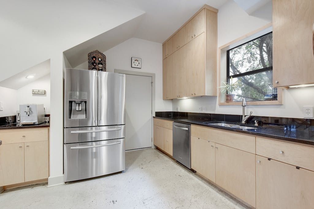 A kitchen with stainless steel appliances and wooden cabinets