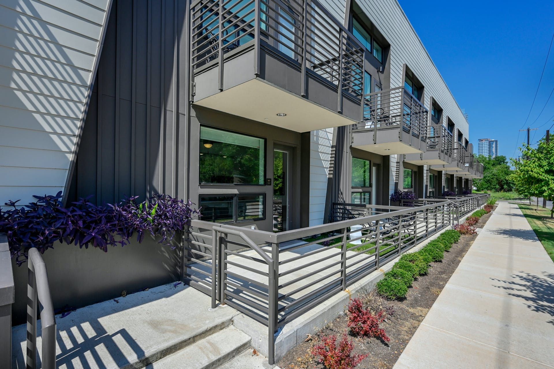 A building with a balcony and stairs leading up to it.