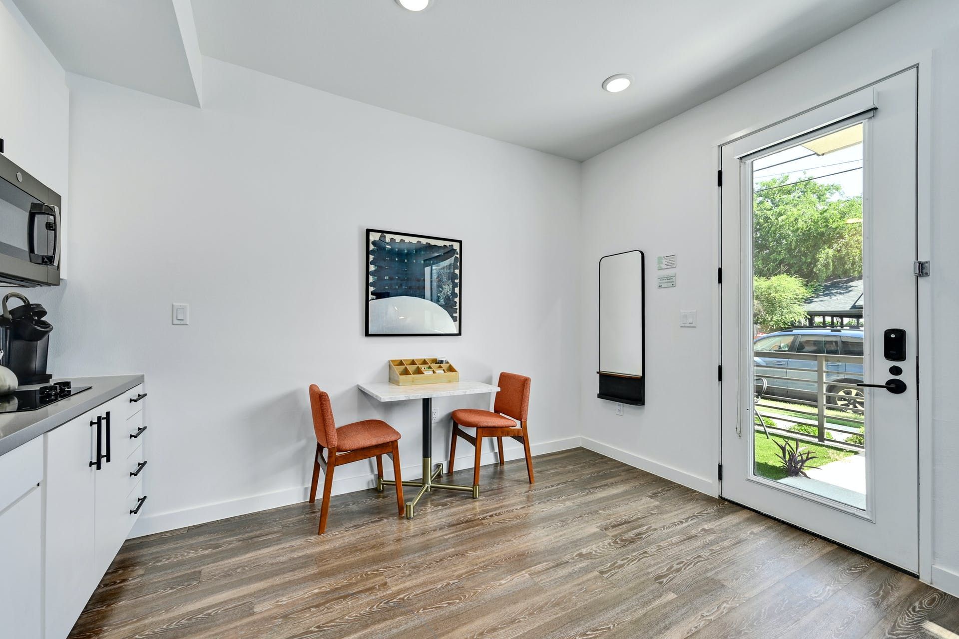 A kitchen with a table and chairs and a door.