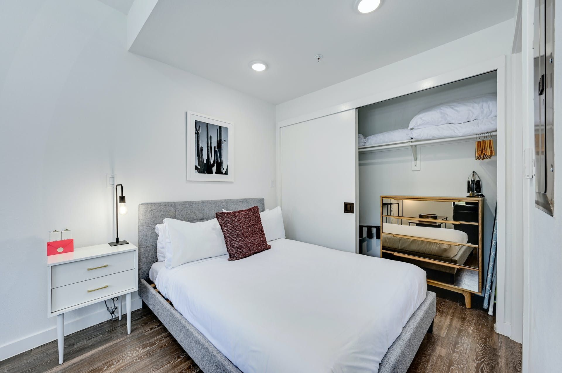 A bedroom with a bed , nightstand , and closet.