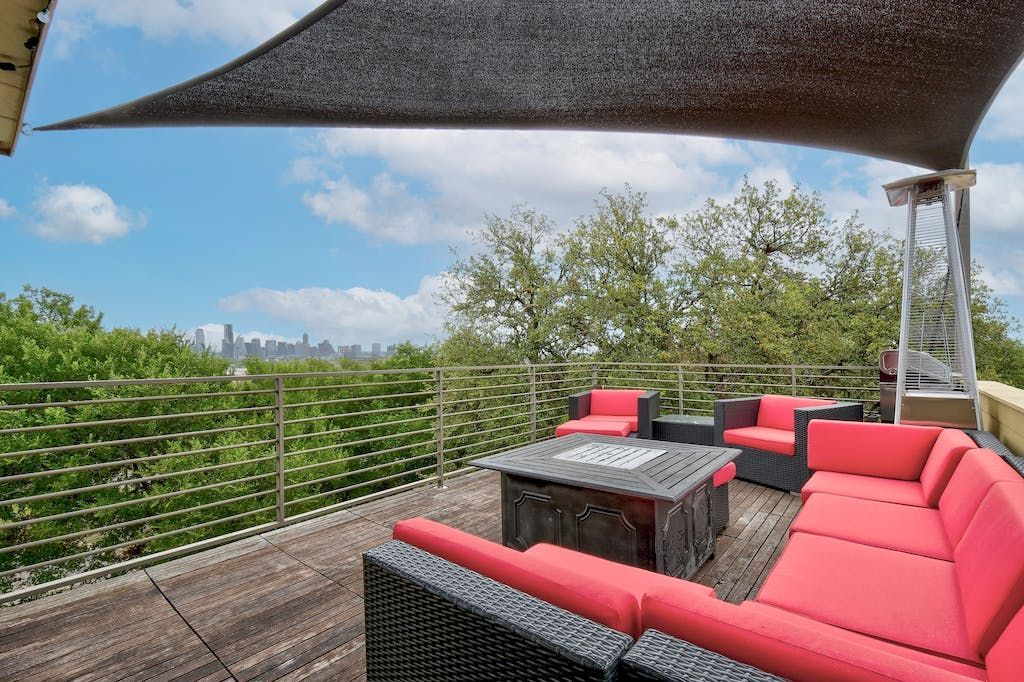 A patio with a lot of furniture and a canopy over it.