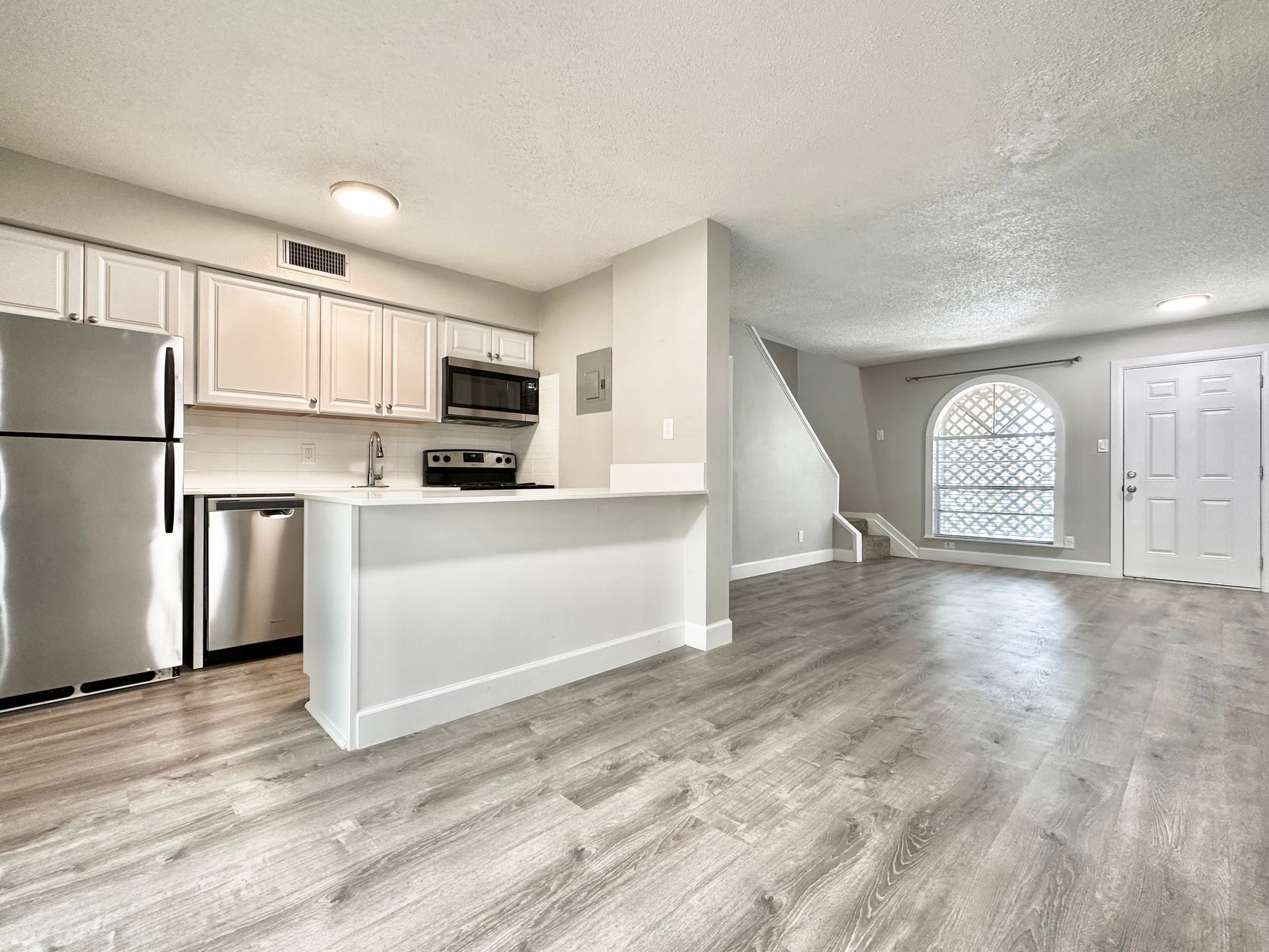 A kitchen with a refrigerator , stove , microwave , and dishwasher.