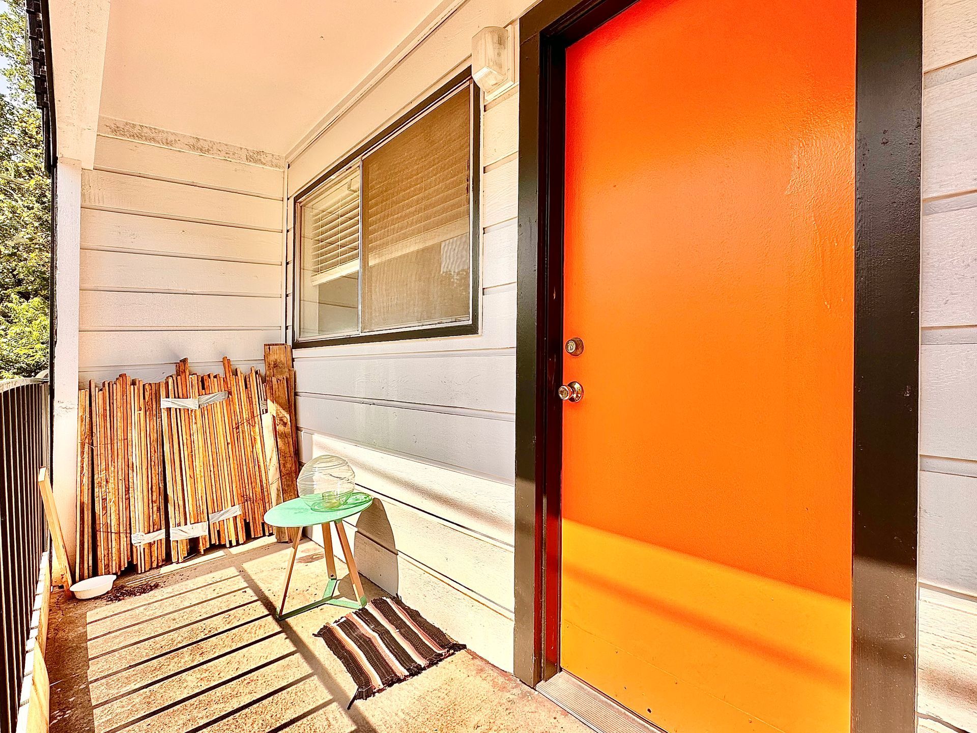 An orange door with a green table in front of it