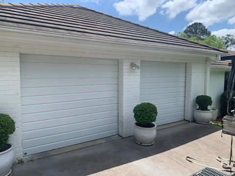 A White House With two White Garage Doors — Schofield's Garage Doors in Robertson, NSW
