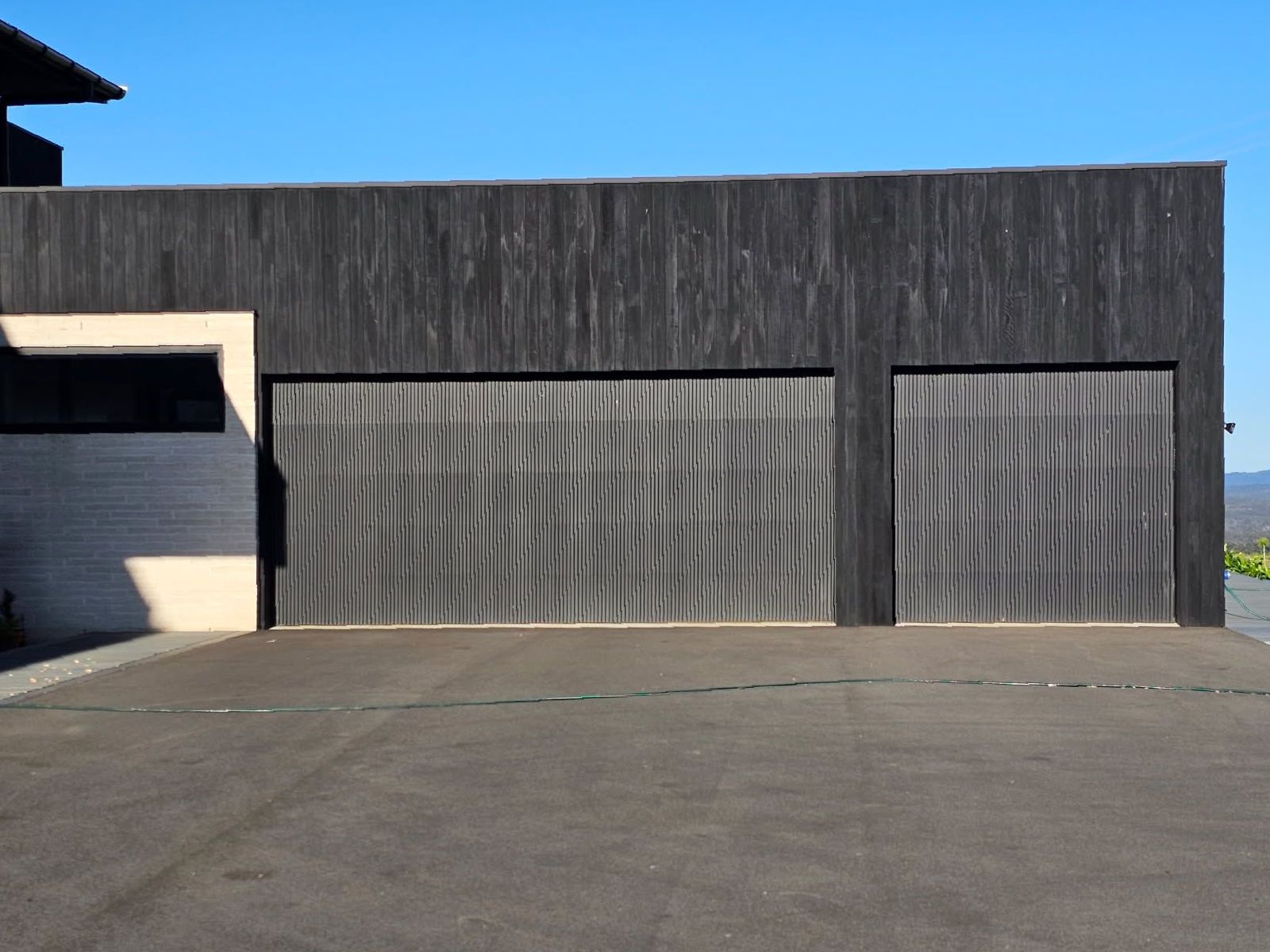 A Modern garage and a blue sky — Schofield's Garage Doors in Robertson, NSW