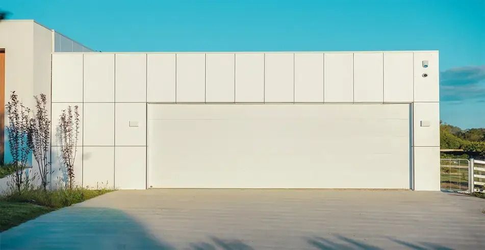 A Wooden Garage Door is Open in a Brick Building — Schofield's Garage Doors in Robertson, NSW