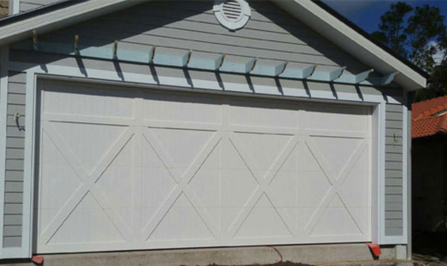 A White Garage Door on a Gray House — Schofield's Garage Doors in Robertson, NSW