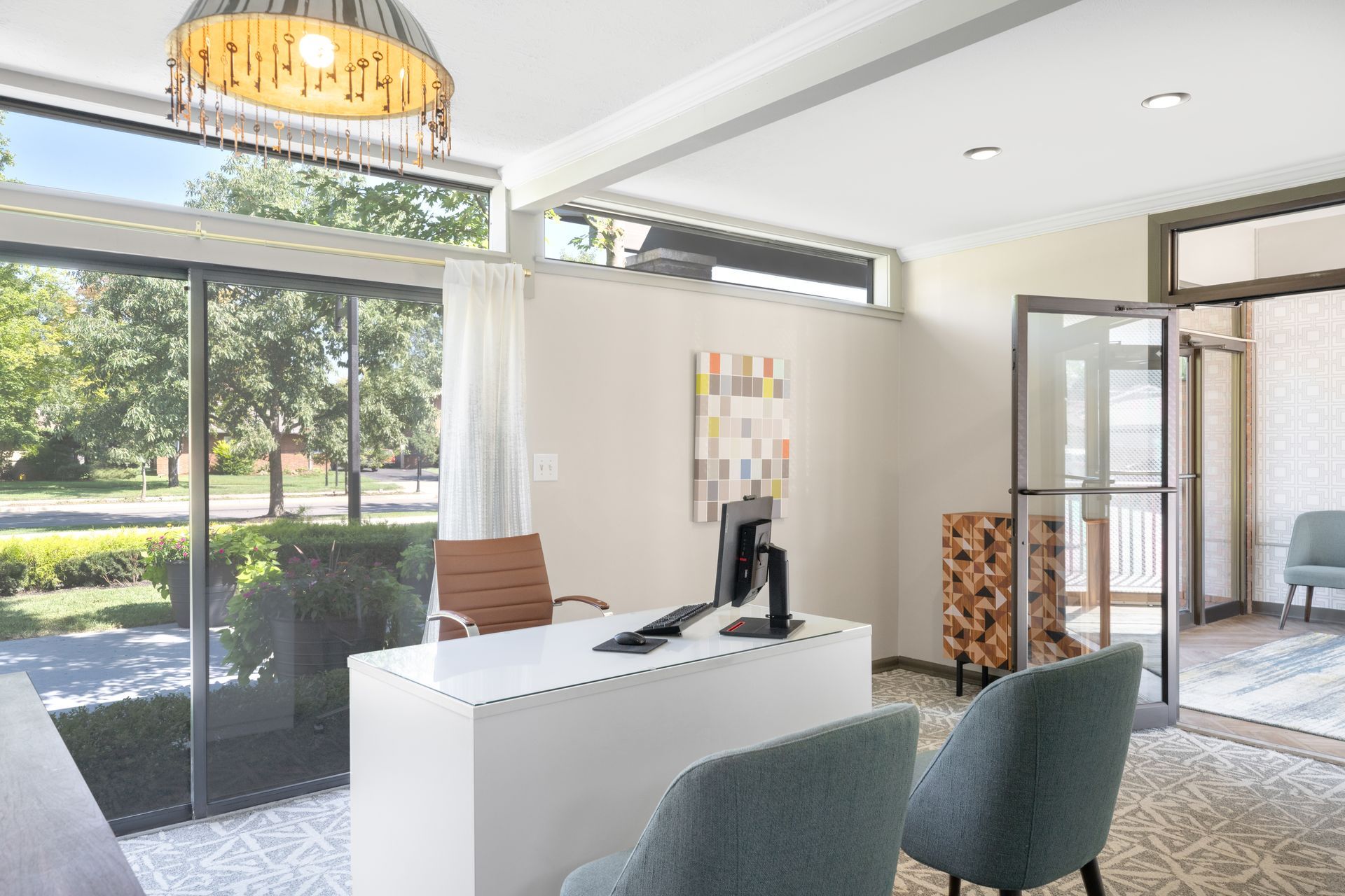 There is a desk with a computer on it in the middle of the room.