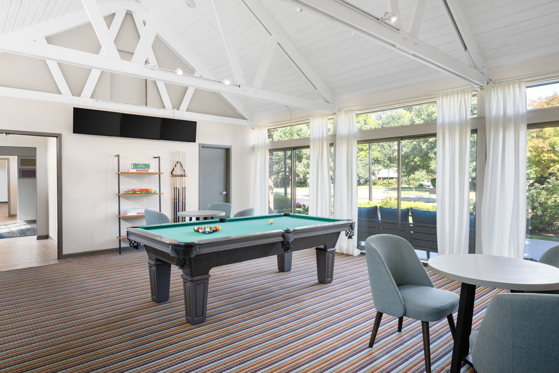 There is a pool table in the middle of the room.