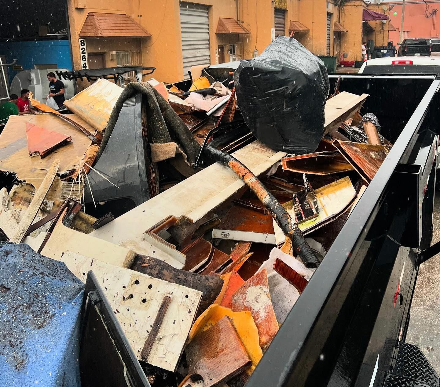 A man wearing a mask is loading boxes into a van