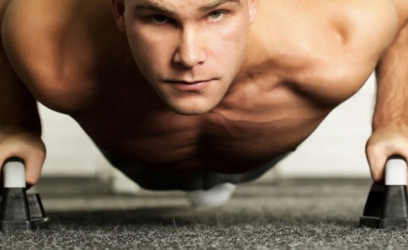 A woman is doing a handstand on the floor.