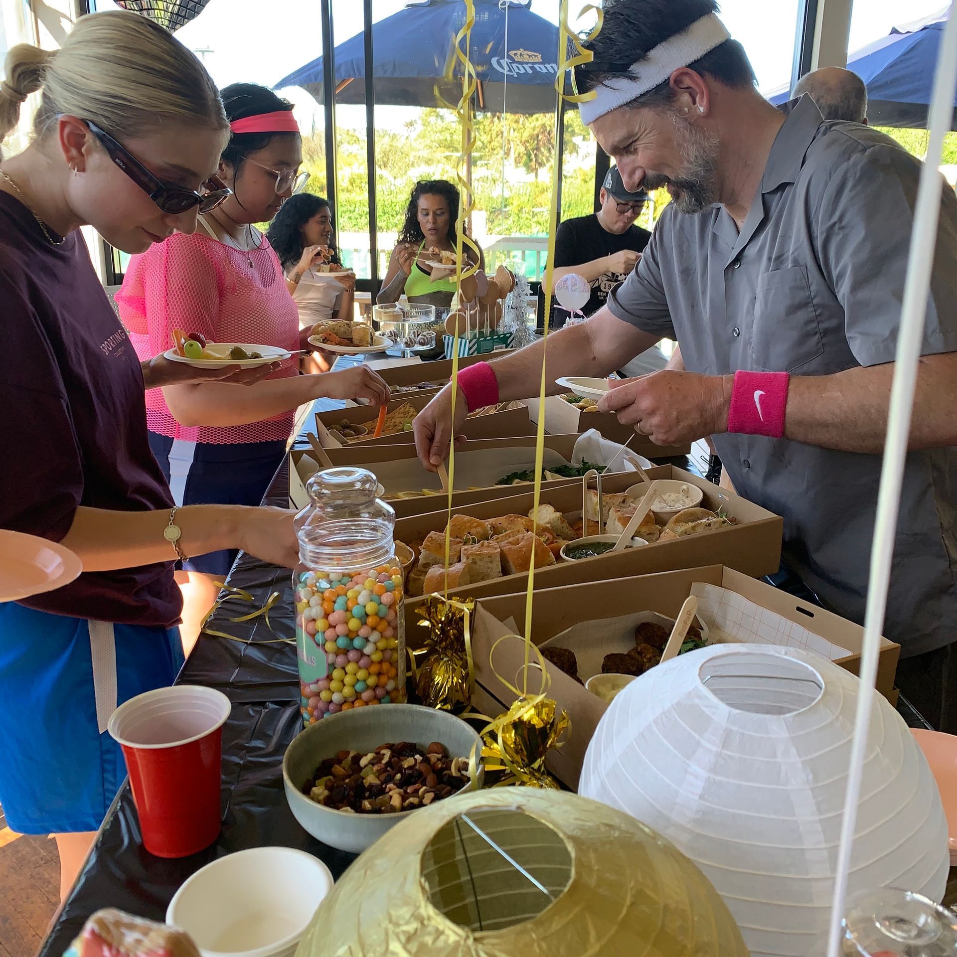 A woman is doing a handstand on a yoga mat in a room.