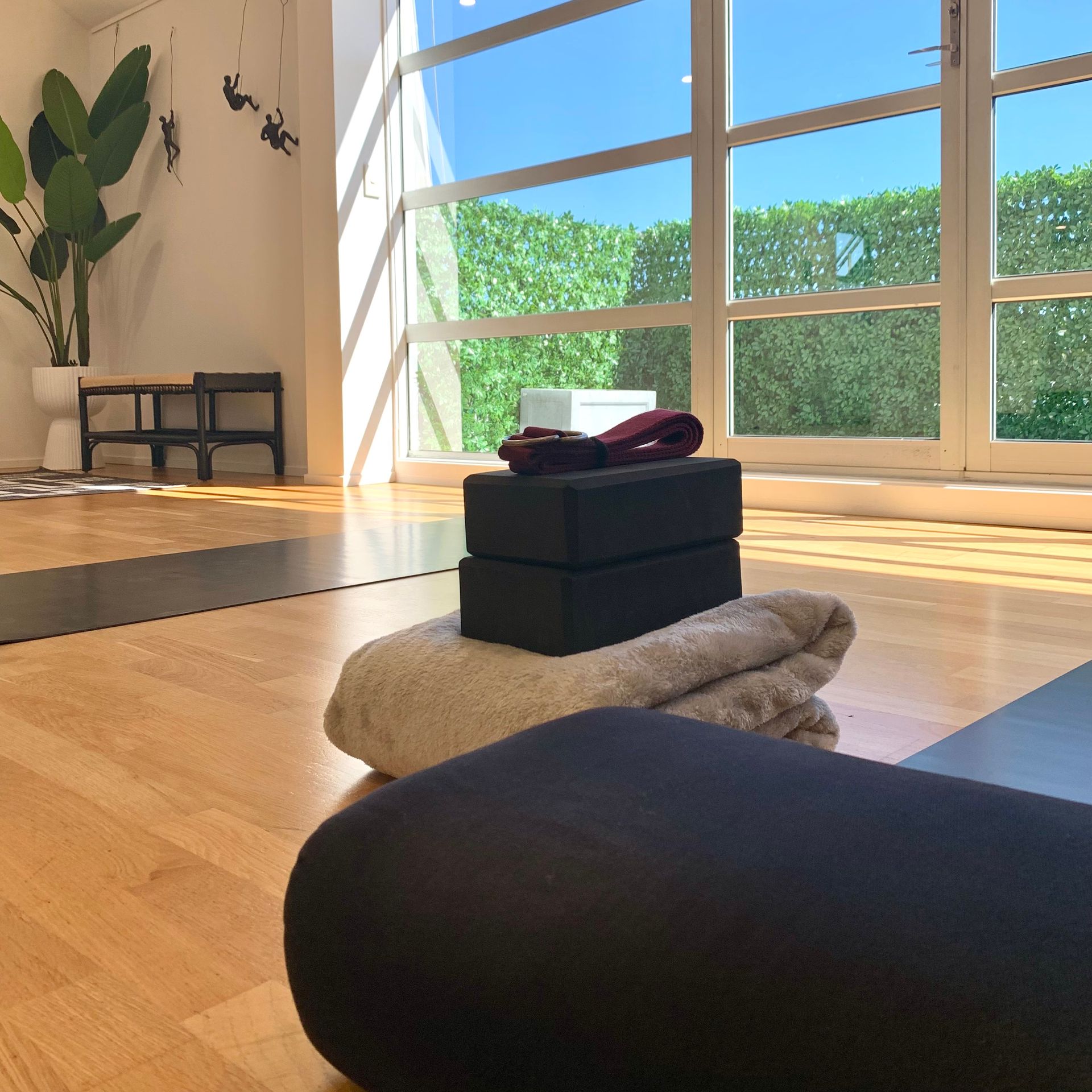 A woman is doing a yoga pose on a mat in a room.