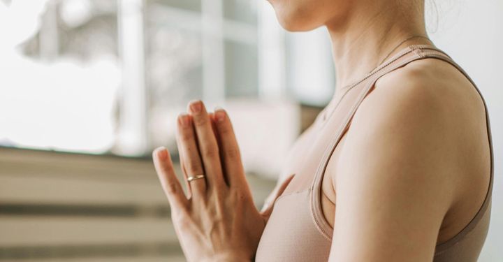 A bottle of water is sitting on a box in a yoga studio.