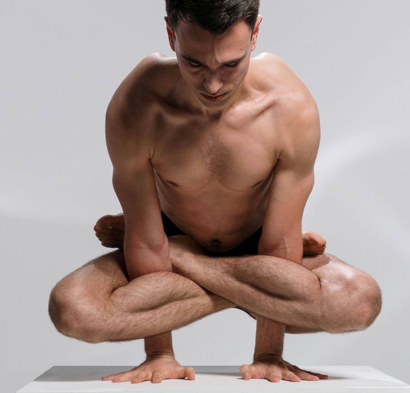 Ais performing an arm balance