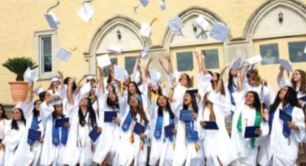 A group of graduates are throwing their caps in the air.