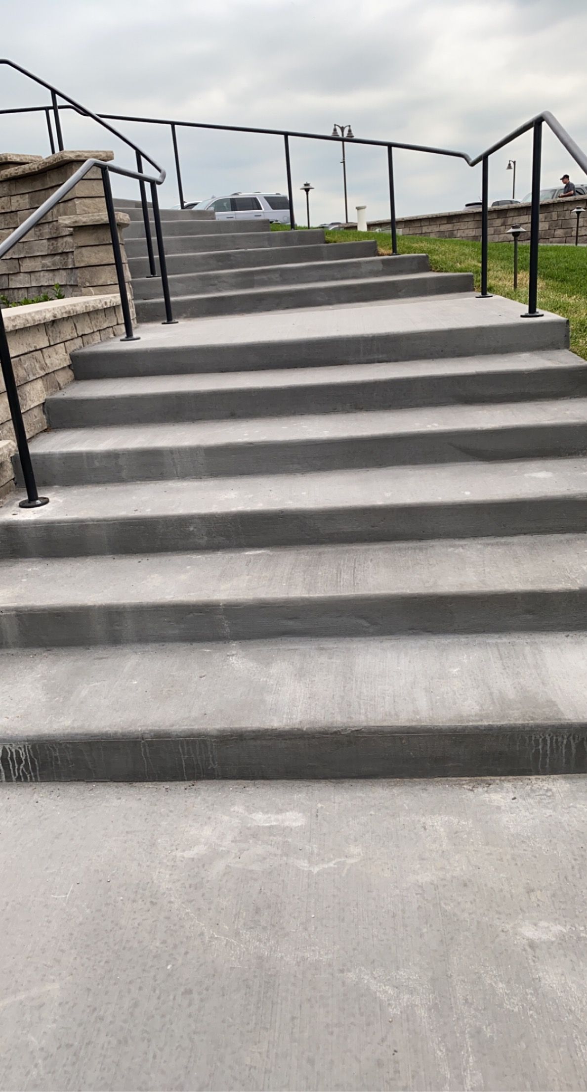White house with black trim, walkway, and landscaping.