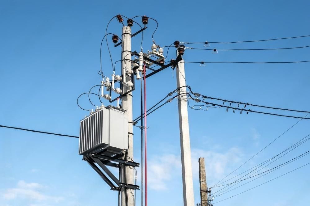 a transformer is sitting on top of an electrical pole .