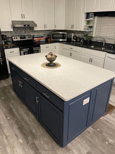 There is a large island in the middle of the kitchen.