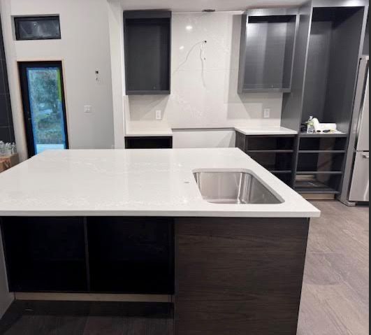 A kitchen with a large island and a sink