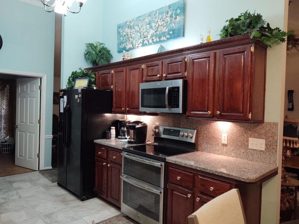 A kitchen with stainless steel appliances and wooden cabinets