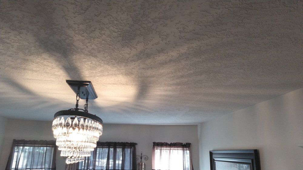 A chandelier is hanging from the ceiling in a living room.