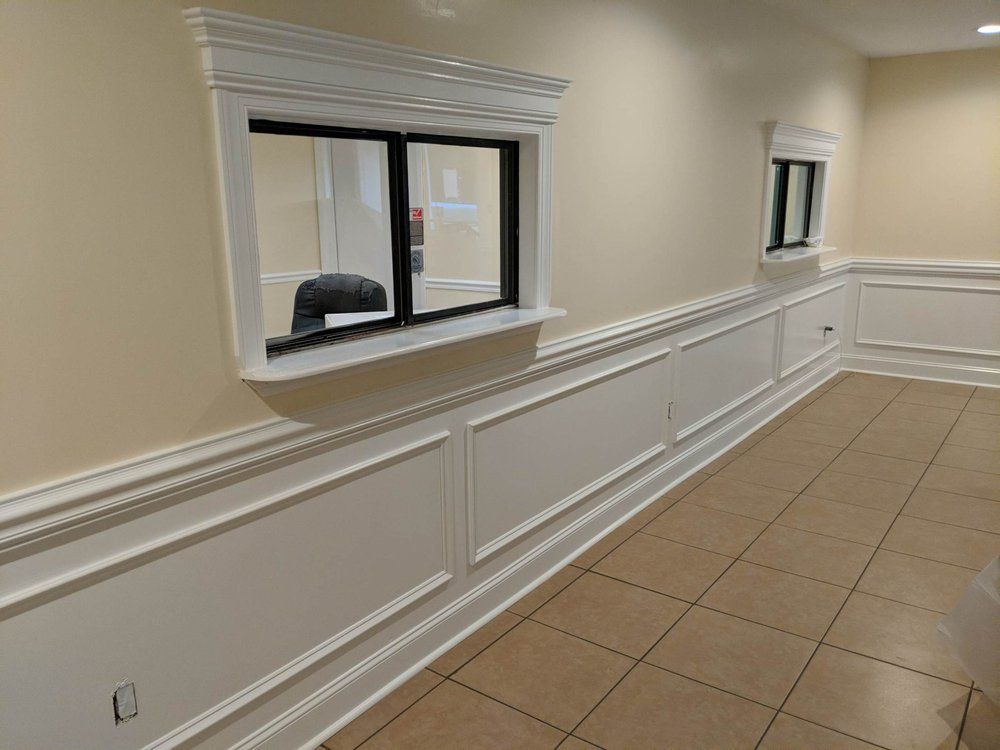 A long hallway with two windows on the wall