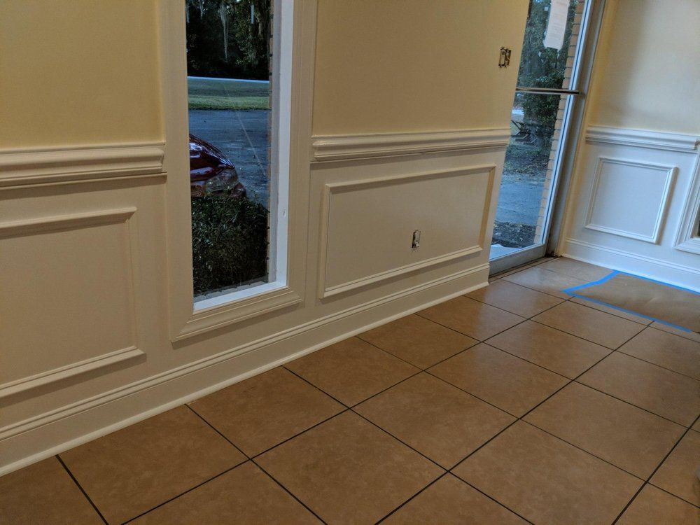 A hallway with tile floors and white trim