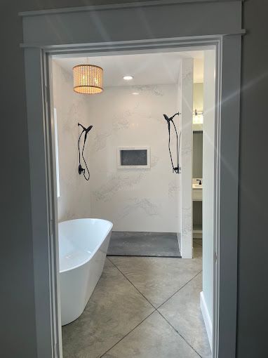 A bathroom with a bathtub and a walk in shower.