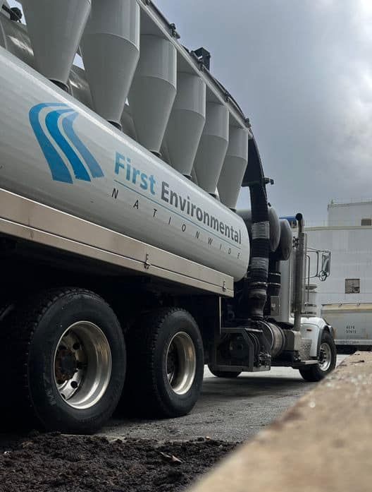 A first environmental national truck is parked at a factory