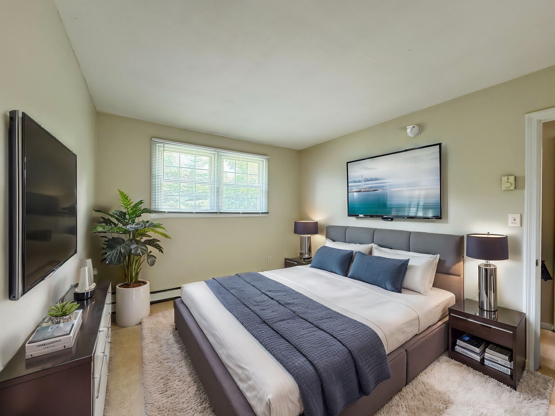A bedroom with a large bed and a flat screen tv — Vernon, CT — A1 Properties