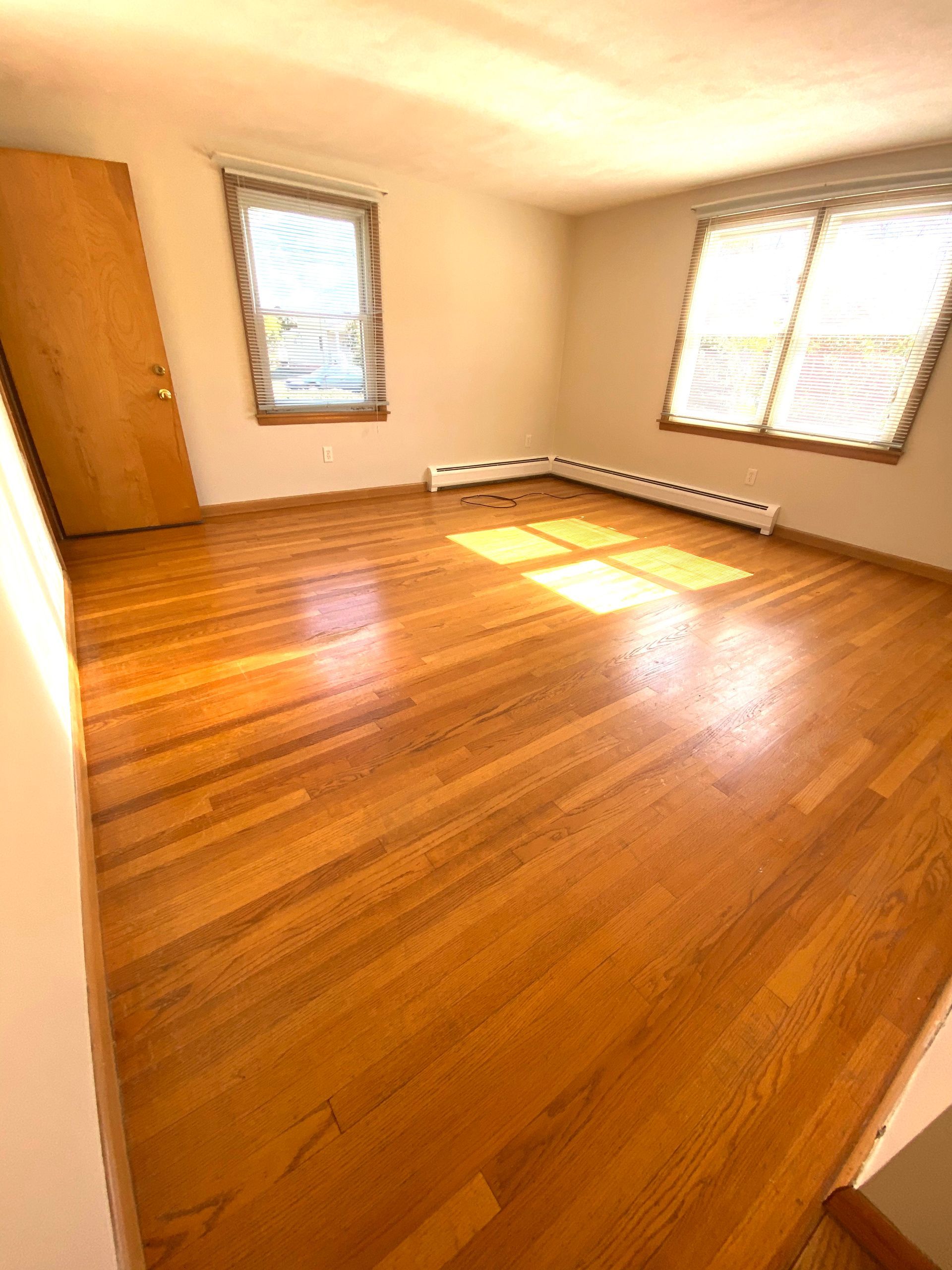 Wooden style room with two windows — Vernon, CT — A1 Properties