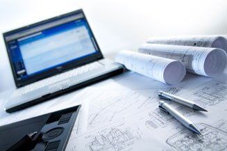 Site Development — Laptop And Blue Print Of A Building in Latham, NY