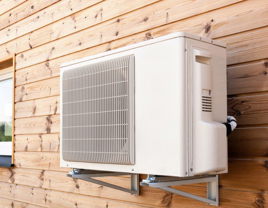 Exterior Airconditioning Unit On A Wooden Wall — Servicing Homes & Businesses in Albion Park, NSW
