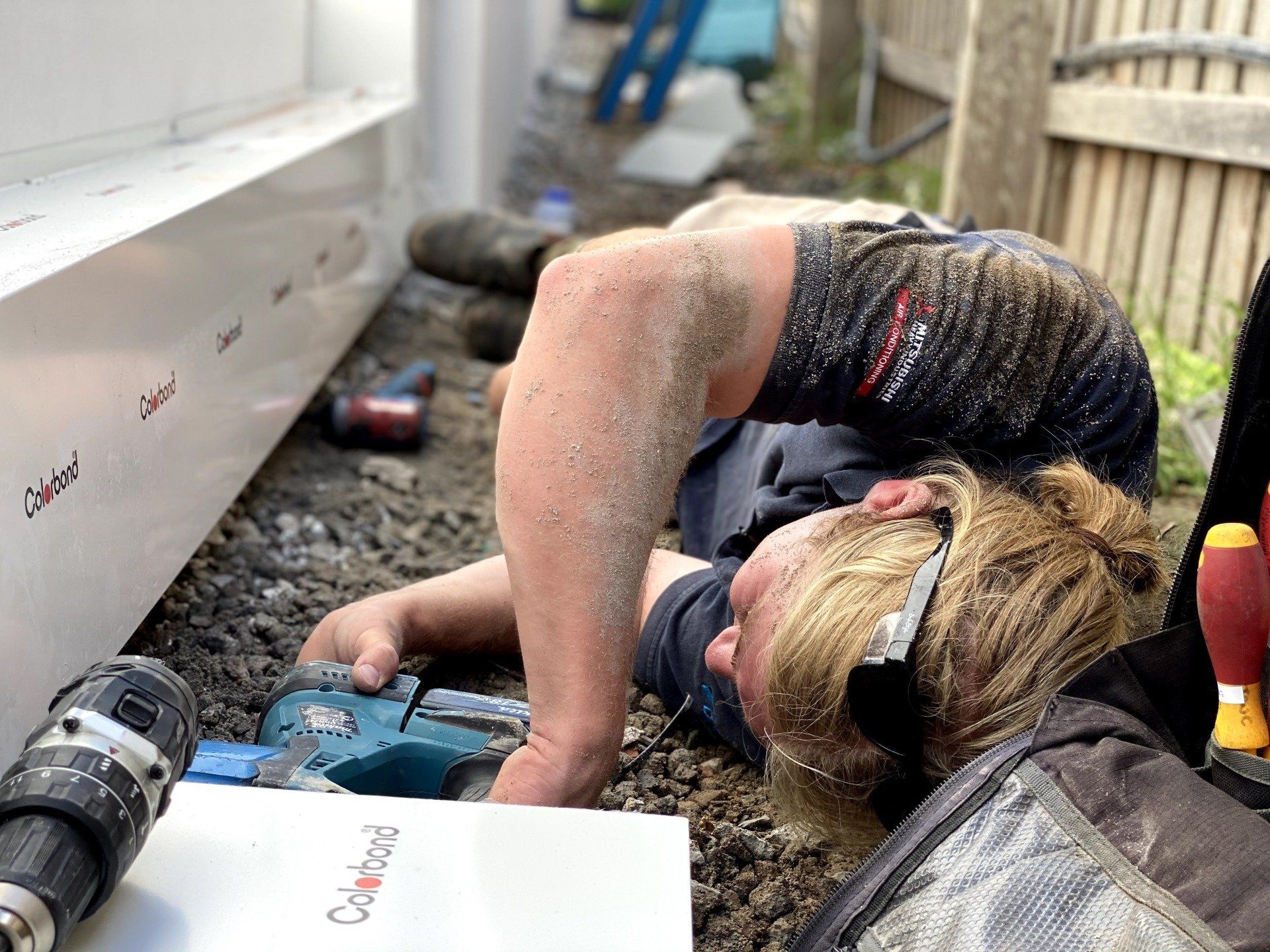 Men Worker With Drill Installing Aircon — Servicing Homes & Businesses in Albion Park, NSW