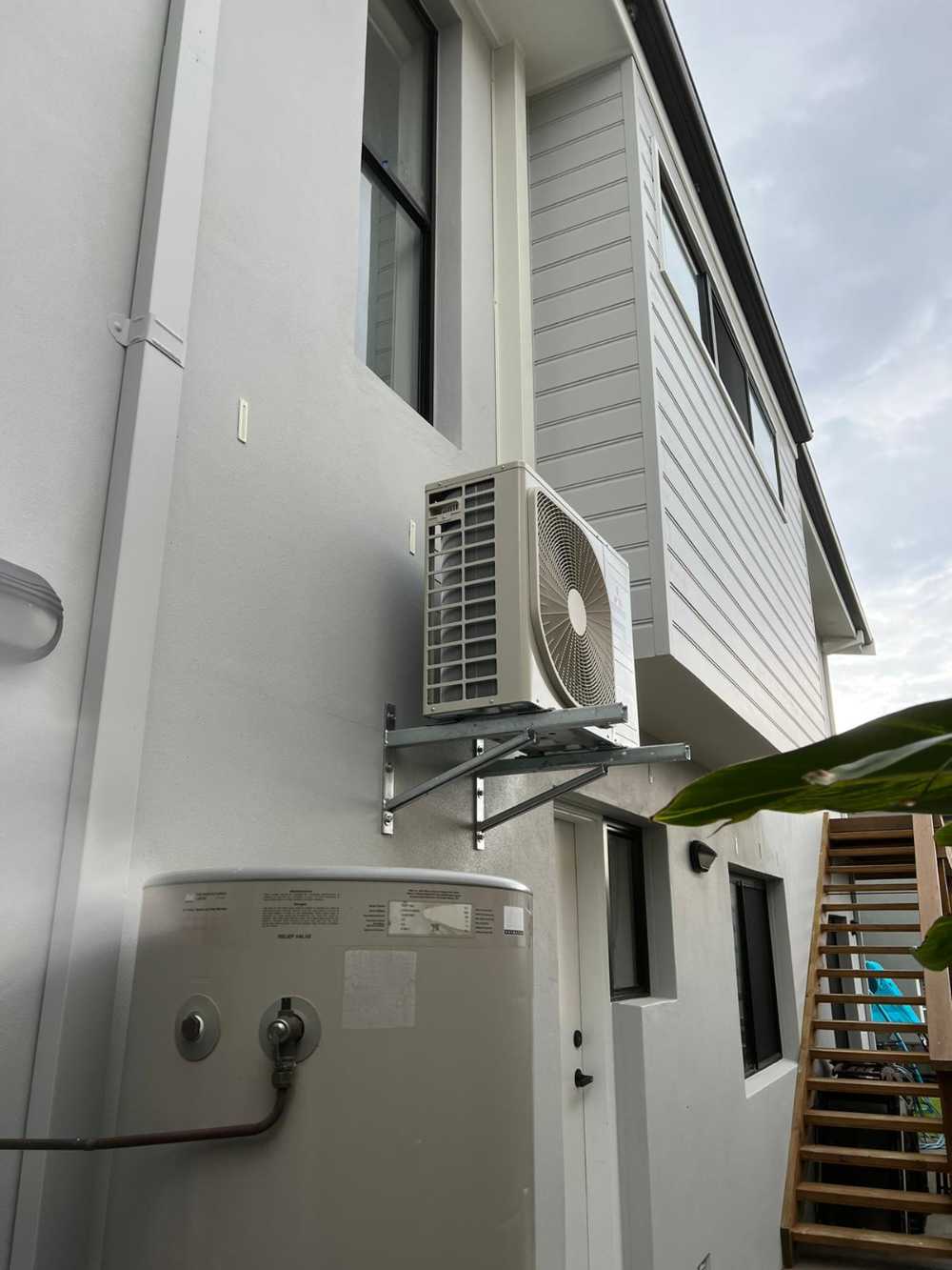 Aircondition System at Side of White house — Servicing Homes & Businesses in Albion Park, NSW