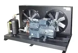 Refrigeration unit with compressor, two fans, and a black tank on a black base.